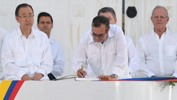 El líder de las FARC Timochenko firma el documento ante la mirada del secretario general de la ONU Ban Ki-moon (Foto: AFP)